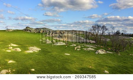 Green Hills With Boulders And Tree Aerial Photo