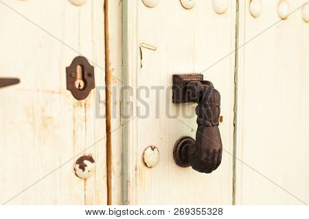 Close-up. Vintage Handle For Knocking On The Door In The Form Of A Hand.