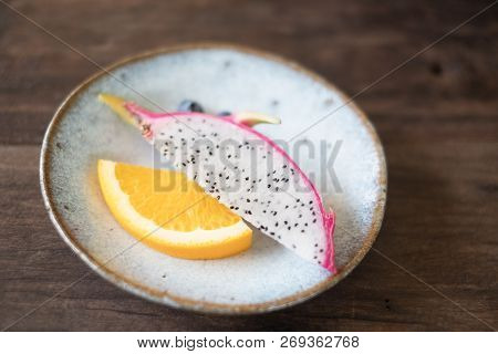 Closeup Dragon Fruit And Orange On White Dish