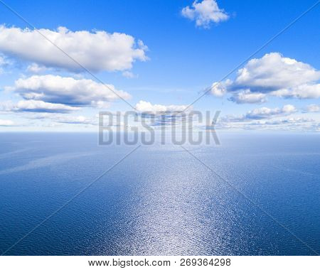 Aerial View Of A Blue Sea Water Background And Sun Reflections. Aerial Flying Drone View. Waves Wate