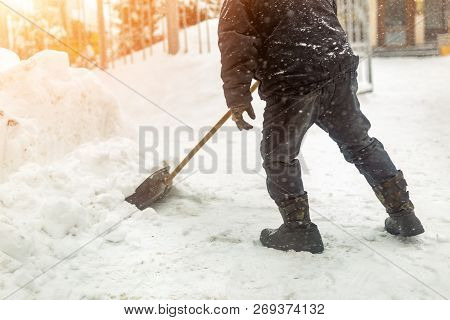 Man Removing Snow From Sidewalk After Heavy Snowfall. Snowstorm And Blizzard Aftermath In Winter. Sl