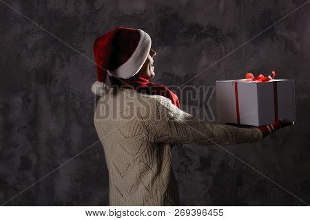 Christmas Gift Concept. Man In Santa Hat Bring Gift For You. Attractive Man Hold Box.  Christmas And