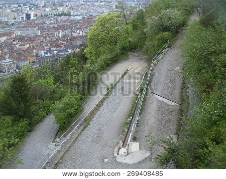 A Gravelled Serpentine Mountain Road In Grenoble.