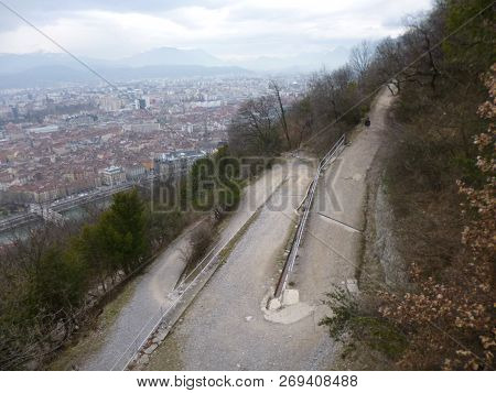 A Gravelled Serpentine Mountain Road In Grenoble.