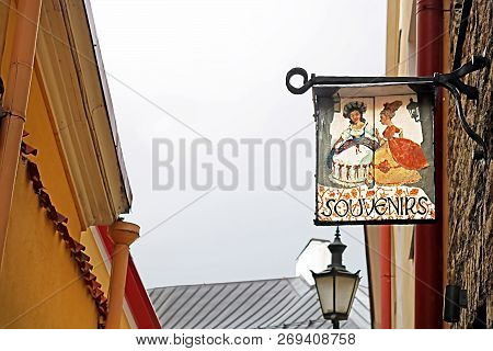 Tallinn, Estonia - August 30, 2018: View Of Old Buildings And Signboard Of Souvenirs Shop On Verine 