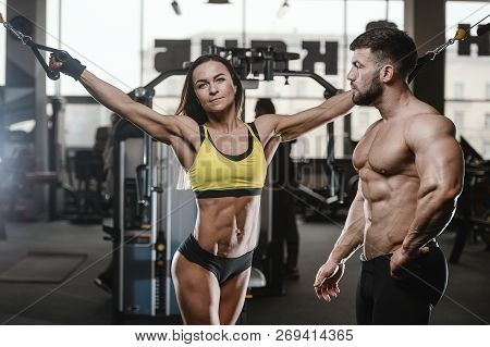Handsome Young Muscular Caucasian Man And Woman Working Out Training In The Gym Gaining Weight Pumpi
