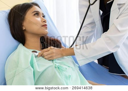 Asian Doctor make routine health check with patient in hospital ward