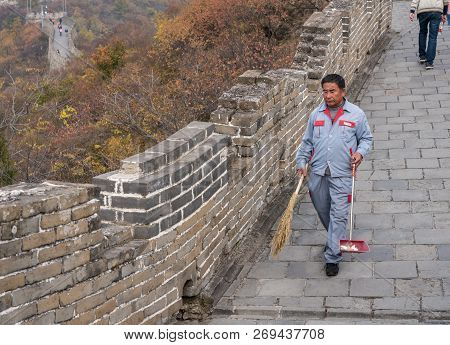 Mutianyu, China - 20 October 2018: Cleaner On The Great Wall Of China At Mutianyu Sweeping Litter