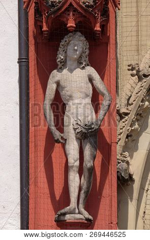 WURZBURG, GERMANY - JULY O4, 2018: Statue of Adam on the portal of the Marienkapelle in Wurzburg, Bavaria, Germany