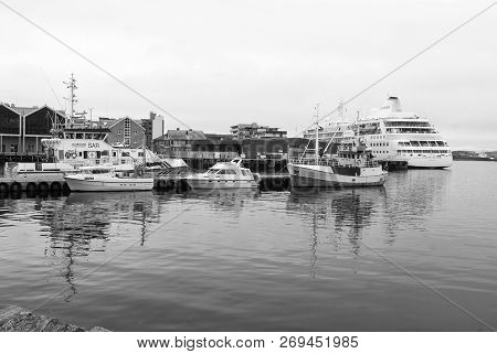 Hammerfest, Norway - January 21, 2010: Ships And Boats In Sea Dock On Grey Sky. Water Transport And 