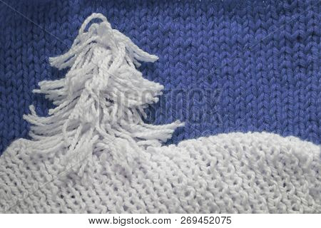 Hadmade Christmas Tree On Blue Knitted Woolen Background With Copy Space For Text Christmas Concept