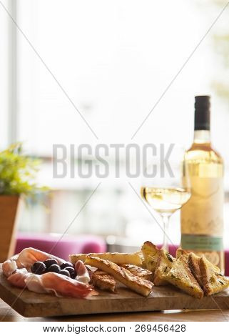 Appetizers Table With Italian Antipasti Snacks And Wine In Glass. Brushetta Or Authentic Traditional