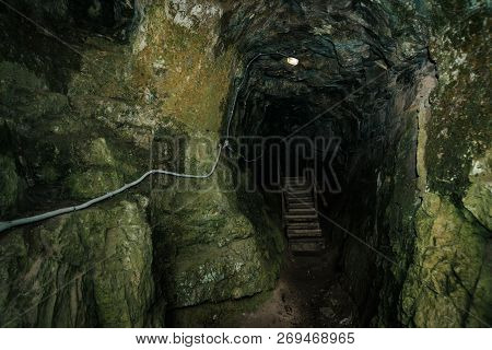 Beautiful Cave. View From Inside Dark Dungeon. Textured Walls Of Cave. Background Image Of Undergrou