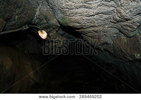 Beautiful Cave. View From Inside Dark Dungeon. Textured Walls Of Cave. Background Image Of Undergrou