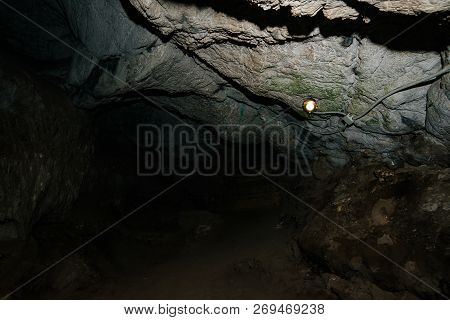 Beautiful Cave. View From Inside Dark Dungeon. Textured Walls Of Cave. Background Image Of Undergrou