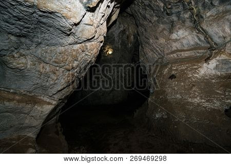 Beautiful Cave. View From Inside Dark Dungeon. Textured Walls Of Cave. Background Image Of Undergrou