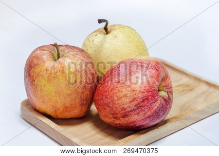 Chainese Pear And Apples On Wooden Tray