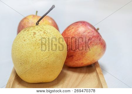 Chainese Pear And Apples On Wooden Tray