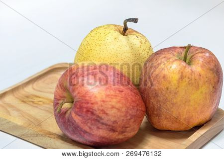 Chainese Pear And Apples On Wooden Tray