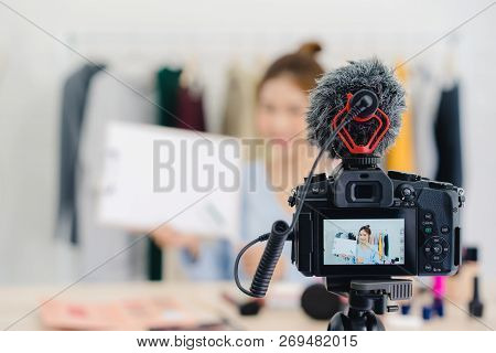 Beauty Blogger Present Beauty Cosmetics Sitting In Front Camera For Recording Video. Beautiful Asian