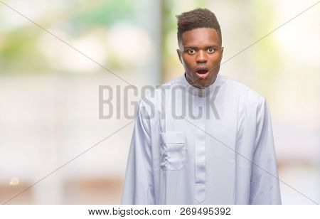 Young arabic african man wearing traditional djellaba over isolated background afraid and shocked with surprise expression, fear and excited face.