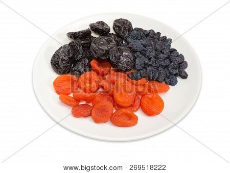 Traditional Dried Fruits - Dark-colored Raisins, Dried Plums And Dried Apricots On The White Dish On