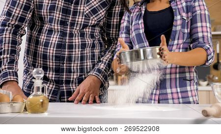 Happy Young Couple Have Fun In Modern Kitchen Indoor While Preparing