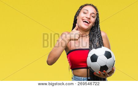 Young braided hair african american with birth mark holding soccer ball over isolated background happy with big smile doing ok sign, thumb up with fingers, excellent sign