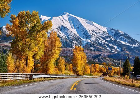 Highway in Colorado Rocky Mountains at autumn, USA. Mount Sopris landscape.