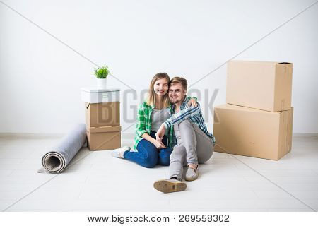 Relocation, Real Estate And Moving Concept - Young Cheerful Couple Moving Into Their New Home