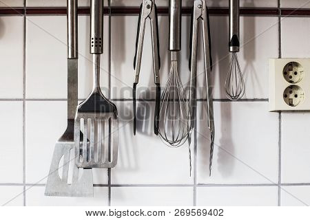 The Kitchenware Hanging On The Wall In The Kitchen Objects