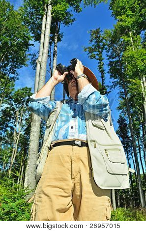 Старший birdwatcher в лесу
