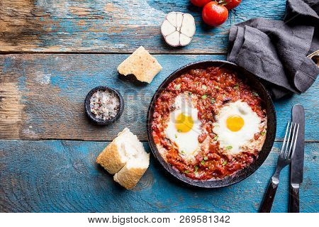 Shakshuka, Fried Eggs In Tomato Sauce In Iron Frying Pan. Typical Israel Food. Top View.