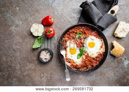 Shakshuka, Fried Eggs In Tomato Sauce In Iron Frying Pan. Typical Israel Food. Top View.