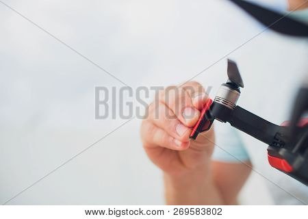 Red Drone Catching Control By Man Hands. Lays Out Propellers