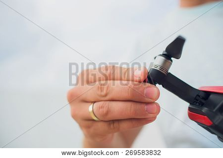 Red Drone Catching Control By Man Hands. Lays Out Propellers