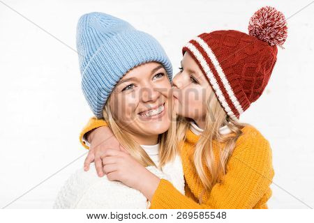Family Portrait Of Happy Mother And Daughter Looking At Camera In Winter Clothes Isolated On White