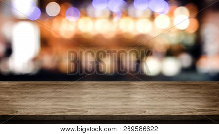Wood Table Top With Blur Nightclub Bar Counter With Bokeh Light Background,banner Mock Up For Displa