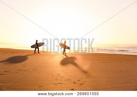 Beautiful beach lansdscape with surfers ready to hit the waves