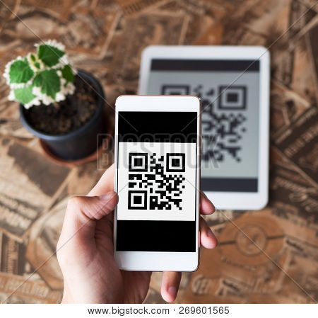 Qr Code Payment Transaction Using Mobile Smartphone And Tablet Devices. Scanning Qr Code From The Ta
