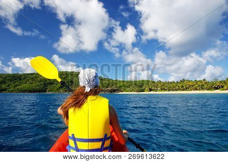 Young Woman Kayaking Near Drawaqa Island In Yasawas, Fiji. The Yasawa Group Consists Of 6 Main Islan