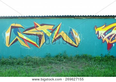Full And Acomplished Graffiti Artwork. The Old Wall Decorated With Paint Stains In The Style Of Stre