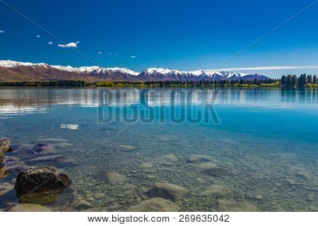 Lake Ruataniwha, New Zealand, South Island, trees and mountains, water reflections