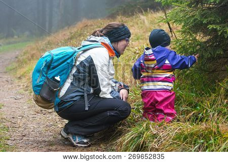 Active Mother Exploring Nature With Her Daughter.