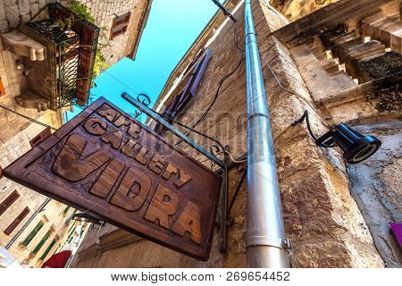Art Gallery Vidra, Kotor Old Town, Montenegro - August 2014. A Wooden Plate With An Inscription Carv