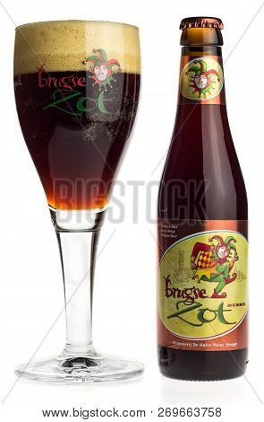 Groningen, Netherlands - November 17, 2018: Bottle And Glass Of Brugse Zot Dubbel Beer Isolated On A