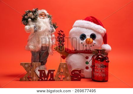 Santa Claus, Snoman Toy And Wooden Xmas Text Sign. Seasonal Presents For December Holiday