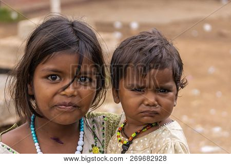 Angadihalli, Karnataka, India - November 2, 2013: Dual Face Closeup Of Young Girl Carrying Her Young