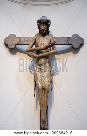 WURZBURG, GERMANY - JULY O4, 2018: Schmerzensmannkreuz, Jesus on the cross, his arms crossed like a gesture of embrace, Neumunster Collegiate Church in Wurzburg, Germany