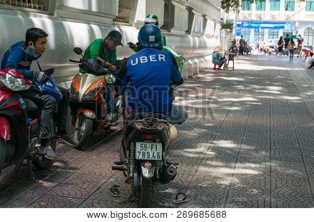 Ho Chi Minh City, Vietnam - August 24, 2017: Uber Scooter And Motorcycle Drivers Having Rest On Stre